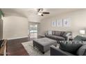 Bright living room featuring hardwood floors, a ceiling fan, neutral paint, and a view to the backyard at 3415 E Anderson Dr, Phoenix, AZ 85032