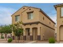 A two-story home features a covered porch and neutral stucco, complemented by simple desert landscaping at 3713 S 54Th Ln, Phoenix, AZ 85043