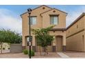 Front exterior of a two-story home with beige stucco, a tile roof, and desert landscaping at 3713 S 54Th Ln, Phoenix, AZ 85043