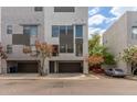 Modern townhouse showcasing a two-car garage, contemporary architecture, and mature landscaping at 4617 E Culver St, Phoenix, AZ 85008