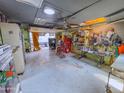 View of garage with a skylight, pegboard walls, and tools, with the garage door open to the outside at 4621 E Desert Forest Trl, Cave Creek, AZ 85331