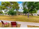 A picturesque outdoor scene showcasing a grassy lawn and mature trees, complemented by comfortable seating at 5037 N 81St St, Scottsdale, AZ 85250