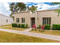 Inviting front of the home with well-kept lawn, trimmed bushes and two comfy chairs at 5037 N 81St St, Scottsdale, AZ 85250