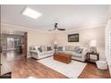 Bright living room featuring hardwood floors, ceiling fan, couches and stylish decor at 5037 N 81St St, Scottsdale, AZ 85250