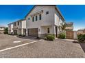 Townhome row features attached garages, neutral color schemes, tidy landscaping, and private entrances at 5518 S Dillon Cir, Mesa, AZ 85212