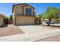 A two-story home featuring a two-car garage, neutral color palette, and low-maintenance landscaping at 5553 W Minton Ave, Laveen, AZ 85339