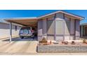 Charming single-story home featuring a covered carport and beautifully landscaped front yard at 5735 E Mcdowell Rd # 464, Mesa, AZ 85215