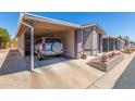 Charming single-story home featuring a covered carport and beautifully landscaped front yard at 5735 E Mcdowell Rd # 464, Mesa, AZ 85215