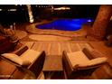 Cozy backyard patio with ambient string lights and seating provides a wonderful outdoor retreat for relaxing at 711 W El Alba Way, Chandler, AZ 85225