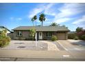 Charming one-story home showcasing desert landscaping, large front yard, and a welcoming entrance at 711 W El Alba Way, Chandler, AZ 85225