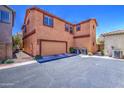 Exterior view of a home with a two car garage and air conditioning units at 7242 S 48Th Gln, Laveen, AZ 85339