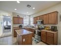 Bright kitchen featuring stainless steel appliances, ample cabinet space, and a functional center island at 7242 S 48Th Gln, Laveen, AZ 85339