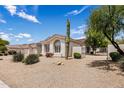 A view of the side of a home with desert landscaping including a Saguaro Cactus at 7492 E Buteo Dr, Scottsdale, AZ 85255