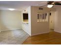 Open-concept living area with hardwood floors, tile and a kitchen bar area at 8702 N Shadow Ln, Peoria, AZ 85345