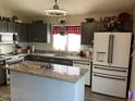 Bright kitchen featuring granite countertops, modern appliances, and ample cabinet space at 9726 E Butte St, Mesa, AZ 85207
