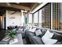 Bright living room with floor-to-ceiling windows, city views, and comfortable contemporary furnishings at 1 E Lexington Ave # 1209, Phoenix, AZ 85012