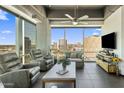 Inviting living room featuring comfortable recliners, modern decor, and stunning city views at 1 E Lexington Ave # 1209, Phoenix, AZ 85012