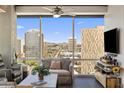 Relaxing living room with a cozy sofa, entertainment center, and a breathtaking city view at 1 E Lexington Ave # 1209, Phoenix, AZ 85012