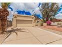 The home features a two car garage and charming desert landscaping at 10244 N 65Th Ln, Glendale, AZ 85302