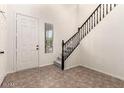 A home's inviting entryway featuring a staircase and natural light streaming through a window at 11834 N 147Th Ln, Surprise, AZ 85379