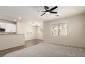 Open-concept living room offering natural light, neutral walls, and plush carpeting at 11834 N 147Th Ln, Surprise, AZ 85379