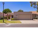Charming single-story home featuring a two-car garage and well-maintained landscaping at 129 Leisure World --, Mesa, AZ 85206