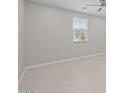 Bright, open room with neutral walls, a ceiling fan and tile flooring, awaiting personalization at 13473 N 158Th Ave, Surprise, AZ 85379