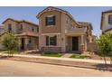 Charming two-story home with neutral stucco, landscaped front yard, covered entrance and tile roof at 13473 N 158Th Ave, Surprise, AZ 85379