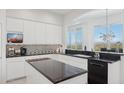 Modern kitchen with white cabinets, black countertops, and stainless steel appliances at 15045 E Sundown Dr, Fountain Hills, AZ 85268