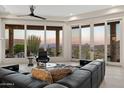 Bright living room featuring a sectional sofa, scenic views, and natural lighting at 15045 E Sundown Dr, Fountain Hills, AZ 85268