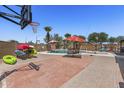 Spacious brick patio featuring a basketball court, inground pool, umbrellas, and room to relax with chairs and kayaks at 1518 E 12Th St, Casa Grande, AZ 85122