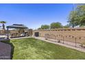 Nicely landscaped backyard featuring synthetic grass, a dining area, a decorative wall, and plenty of room to relax at 1518 E 12Th St, Casa Grande, AZ 85122