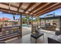 Relaxing covered patio with an outdoor bar and lounge area, perfect for enjoying the backyard pool and sunshine at 1518 E 12Th St, Casa Grande, AZ 85122