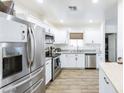Bright, modern kitchen featuring white cabinets, stainless steel appliances, and granite countertops at 1546 W Pierce St, Phoenix, AZ 85007