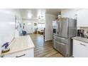 Open kitchen featuring stainless steel appliances and a view into a sun-filled living area at 1546 W Pierce St, Phoenix, AZ 85007