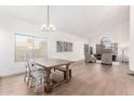 Bright living space with wood floors, vaulted ceilings, and natural light from large windows at 1591 S Sycamore Pl, Chandler, AZ 85286