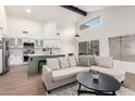 Open-concept living area with modern kitchen and a cozy seating arrangement under high ceilings at 1591 S Sycamore Pl, Chandler, AZ 85286