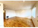 Spacious living room featuring gleaming hardwood floors and ample natural light at 1702 W Tuckey Ln # 209, Phoenix, AZ 85015