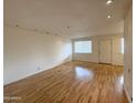 Bright living room with hardwood floors, showcasing a neutral color palette at 1702 W Tuckey Ln # 209, Phoenix, AZ 85015