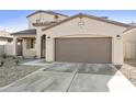 Attractive home with two car garage, concrete driveway, and minimalistic landscaping at 19033 W Rose Ln, Waddell, AZ 85355