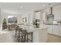 Bright, open kitchen with quartz countertops, a large island, and stainless steel appliances at 19033 W Rose Ln, Waddell, AZ 85355