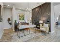 Stylish home office space featuring a modern desk, comfortable chair, and custom accent wall for added elegance at 19420 W San Juan Ave, Litchfield Park, AZ 85340