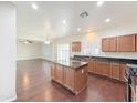 Bright kitchen with an island, stainless appliances, granite counters, and an open layout at 19432 W Morning Glory Dr, Buckeye, AZ 85326