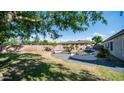 Lush backyard featuring pool with waterfall feature, patio, and green grass, perfect for entertaining guests at 1970 E Yellowstone Pl, Chandler, AZ 85249