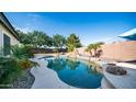 Backyard pool featuring rock waterfall and mature landscaping provides the perfect outdoor retreat at 1970 E Yellowstone Pl, Chandler, AZ 85249