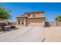 Charming two-story home with a spacious driveway and well-maintained desert landscaping at 21188 N Duncan Dr, Maricopa, AZ 85138
