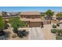Charming two-story home with a spacious driveway and well-maintained desert landscaping at 21188 N Duncan Dr, Maricopa, AZ 85138