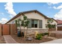 Side view of a cozy home featuring well-kept landscaping and stone accents at 24035 N 171St Dr, Surprise, AZ 85387