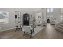 Bright, neutral living room with wood floors, high ceilings, and stylish decor at 2562 E Los Alamos St, Gilbert, AZ 85295
