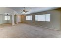 Expansive living room featuring plush carpeting, abundant natural light, and neutral color palette at 25729 W St Charles Ct, Buckeye, AZ 85326